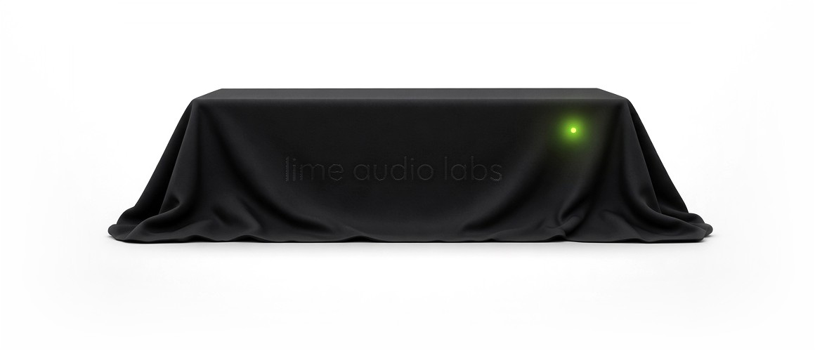 A new product under a black cloth embroidered in black with lime audio labs, with only its small lime light showing through